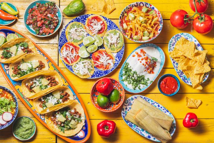 Table full of Mexican food dishes